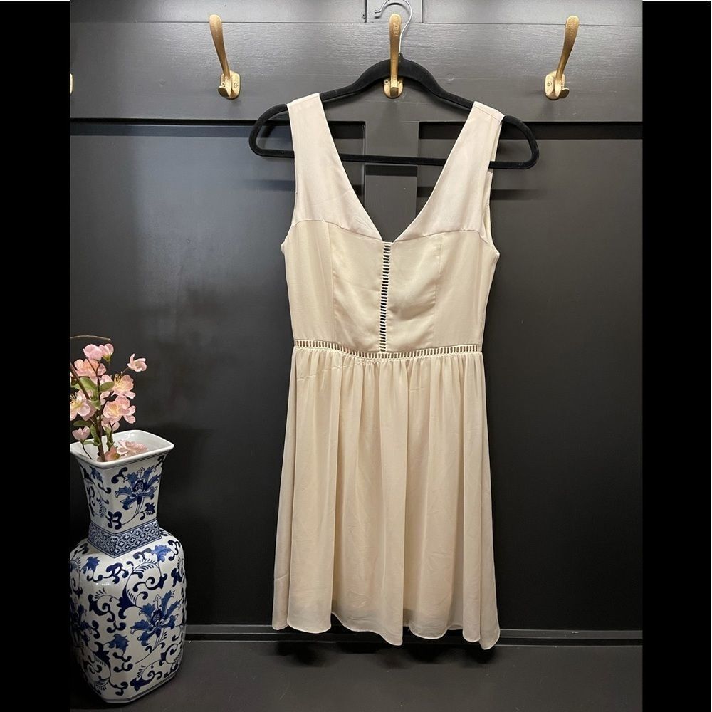 Alythea cream sleeveless dress with cut outs around waist line